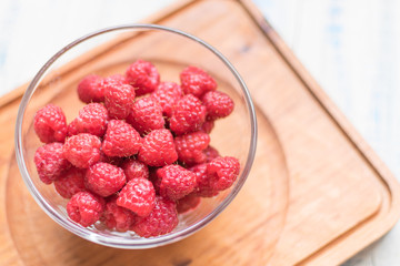 Raspberries in a glass plate.