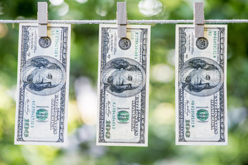 Money Laundering. Money Laundering US dollars hung out to dry. 100 dollar bills hanging on...