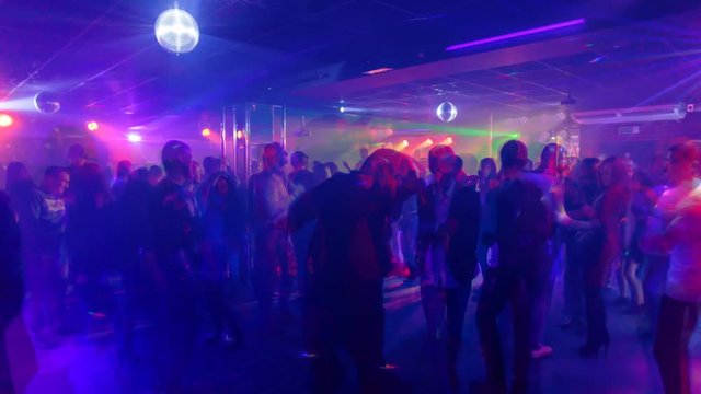 Young people are dancing in a nightclub, timelapse