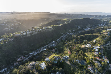 Aerial view of South Beverly Park canyon and hilltop homes in the Santa Monica Mountains above Beverly Hills and Los Angeles, California.  