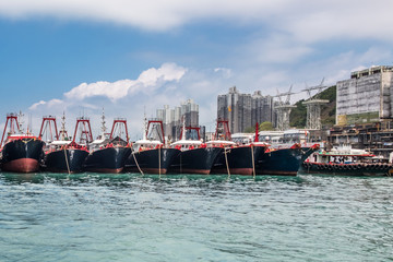 Fishing trawlers anchored in Aberdeen Bay, Hong Kong. Modern nautical vessels in fish industry.