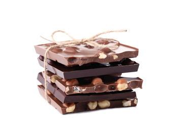 Chocolate pieces with hazelnuts isolated on white background
