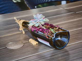 Centerpiece of wine bottle with flowers