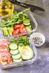 Healthy meal prep containers with quinoa and shrimp