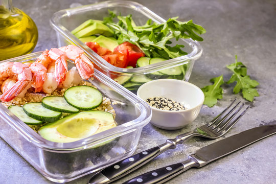 Healthy meal prep containers with quinoa and shrimp