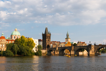 Beautiful and ancient city of Europe - Prague, Czech Republic. View of the city from the observation deck. Small houses and the river Vltava. Charles Bridge and temples.