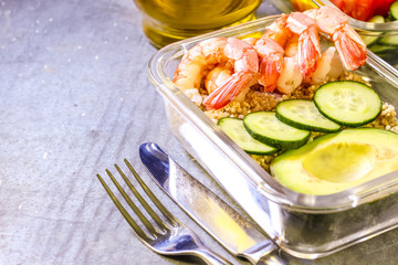 Healthy meal prep containers with quinoa and shrimp
