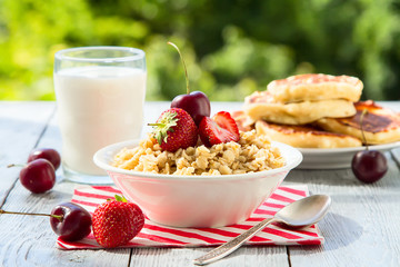 summer berry Breakfast with oatmeal in nature