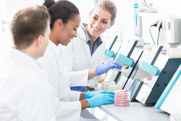 Group of researchers using scientific technology for test of germ samples