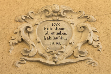 Old roman latin script on statue decoration to Ponte di Legno