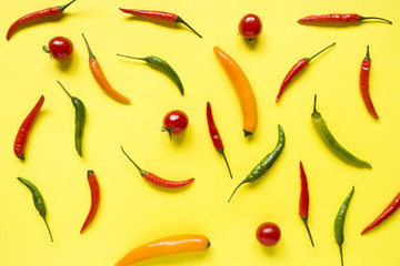 Assorted chili pepper tomato cherry On yellow bright background