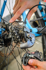 Broken Bicycle Rear Derailleur. Hands Hold the Parts of the Rear Derailleur, Which Fell Apart in Half. Trying to Repair a Breakdown.