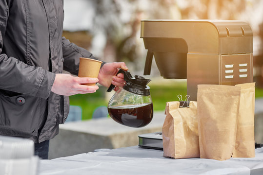 Coffee break service on outdoor event, man pouring coffee