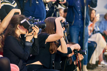 Crowd of journalists taking photo at fashion week presentation - obrazy, fototapety, plakaty