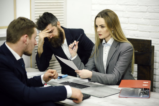 Office atmosphere concept. Business negotiations, discuss working tasks. Business colleagues at meeting, office background. Lady manager tries to organize working process with colleagues in office