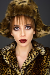 pretty woman in leopard fur coat and hat.