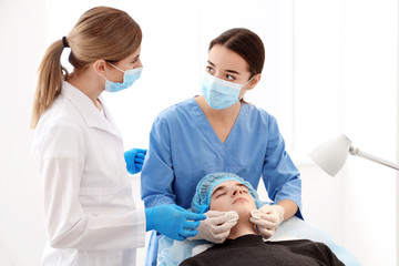 Professional beautician teaching trainee in salon. Apprenticeship concept