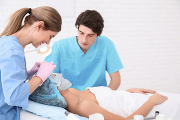 Fototapeta premium Professional beautician teaching trainee in salon. Apprenticeship concept