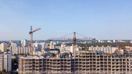 Aerial view on the building with construction cranes