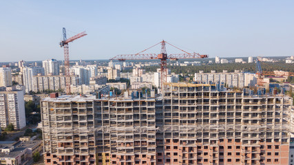 Aerial view on the building with construction cranes