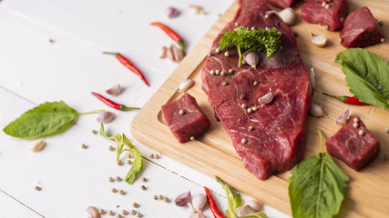 Raw beef on white wood background