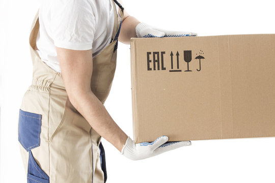 moving service worker holds cardboard box close-up isolated on white background. Relocation man in uniform with box. Mover or loader.
