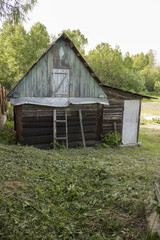 Old  bathhouse in the village in the summer