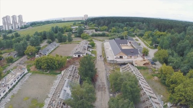 Flying over the city district with old brick abandoned buildings. Clip. Aerial view