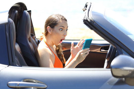 Amazed Driver Watching Media Content In A Smart Phone