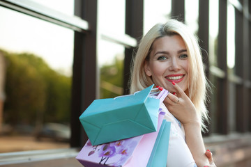 Beautiful woman in shopping. Happy woman with shopping bags enjoying in shopping. Consumerism, shopping, lifestyle concept