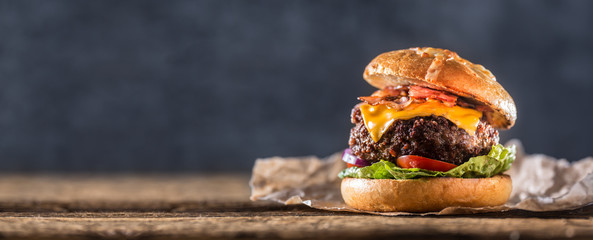 Close-up home made beef burger on wooden table - Powered by Adobe