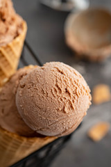 Homemade chocolate ice cream in waffle cones and pieces of dark chocolate 