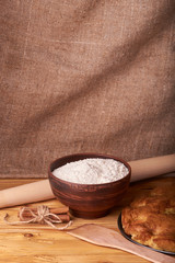 apricot pie and a bowl with flour and other ingredients and tools table