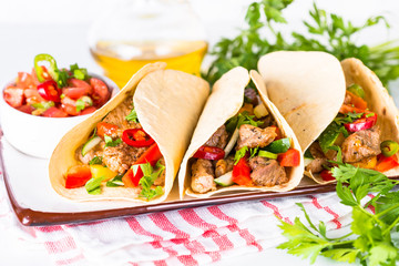 Mexican pork tacos with vegetables and salsa.