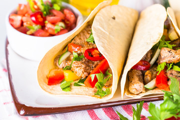 Mexican pork tacos with vegetables and salsa.