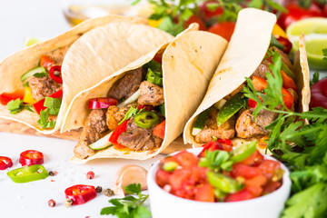 Mexican pork tacos with vegetables and salsa.
