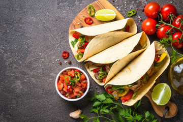 Mexican pork tacos with vegetables and salsa.