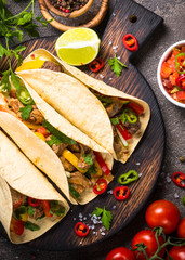 Mexican pork tacos with vegetables and salsa.