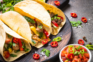 Mexican pork tacos with vegetables and salsa.