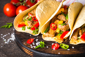 Mexican pork tacos with vegetables and salsa.