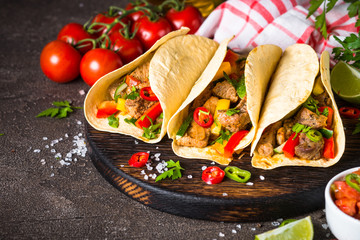 Mexican pork tacos with vegetables and salsa.