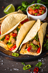 Mexican pork tacos with vegetables and salsa.