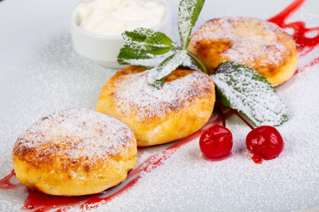Delicious syrniki with cream