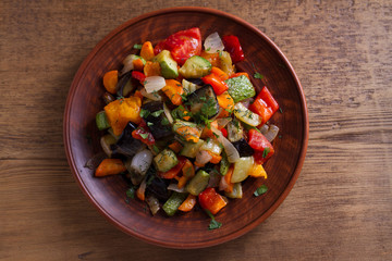 Vegetable stew: eggplant, pepper, tomato, zucchini, carrot and onion. Stewed vegetables. View from above, top studio shot