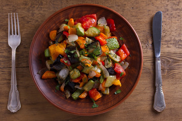 Vegetable stew: eggplant, pepper, tomato, zucchini, carrot and onion. Stewed vegetables. View from above, top studio shot