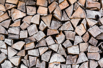 orderly stacked dry chopped firewood, abstract background