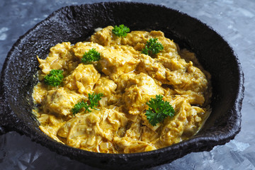 Chicken tikka masala spicy curry meat food in a frying pan. 