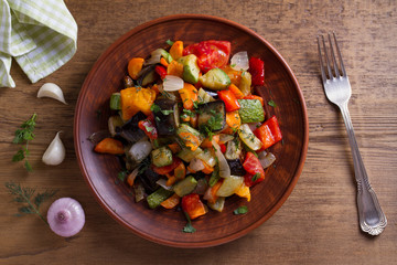 Vegetable stew: eggplant, pepper, tomato, zucchini, carrot and onion. Stewed vegetables. View from above, top studio shot
