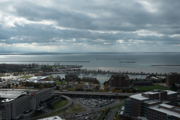 Obraz premium View of the highway and Erie Basin waterfront in Buffalo New York. View of piers and boats from a high vantage point of Buffalo waterfront in upstate New York right before the rain storm.