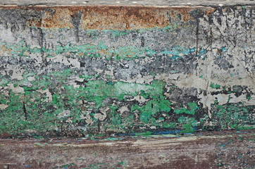 Chipped paint showing several layers of old paint. An old wooden boat abstract background